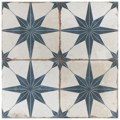 an old tile floor with black and white star designs on the top, bottom and bottom