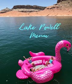 an inflatable pink flamingo float floating on the water with people inside it