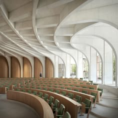 an empty auditorium with rows of chairs and wooden benches