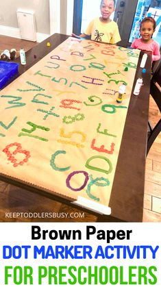 two children sitting at a table with the words brown paper dot marker activity for preschoolers