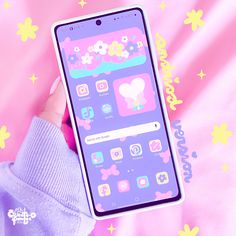 a person holding up an iphone in front of a pink background with flowers and stars