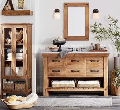 a bathroom with a wooden cabinet and mirror