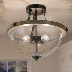 a ceiling light with three lights on it in a living room or dining room area