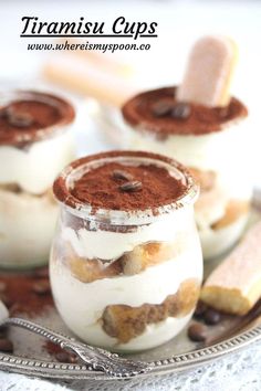 three desserts in small glass jars on a plate