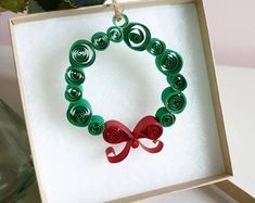 a green and red bracelet in a box