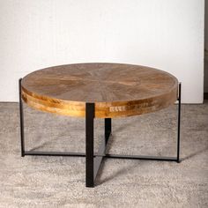 a wooden table sitting on top of a carpeted floor next to a white wall