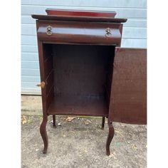 an old wooden cabinet with two drawers