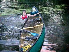 a man in a canoe paddling on the water with oars and paddles