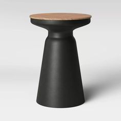 a black stool with a wooden top on a white background, it appears to be in the shape of a cone