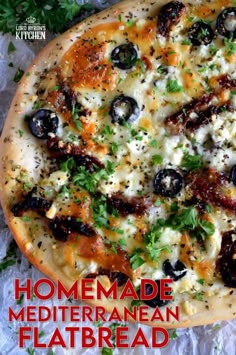 a homemade mediterranean flatbread pizza with olives and parsley