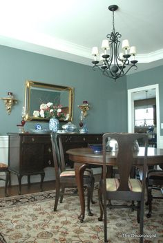 a dining room table with chairs and a chandelier