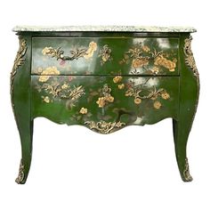 a green painted chest with flowers on it