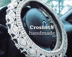 the steering wheel cover is crocheted with white yarn