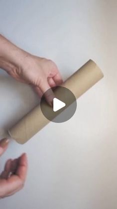 two hands holding a roll of toilet paper with the end rolled up and another hand reaching for it