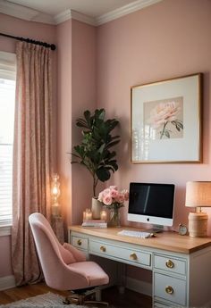 a desk with a computer on top of it next to a pink chair and potted plant