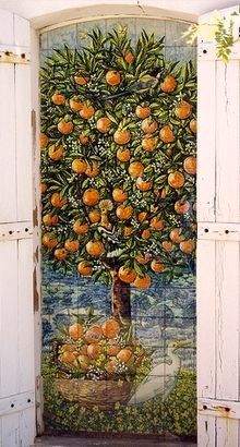 an orange tree painted on the side of a white door with open shutters to let in light