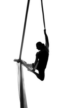 a person hanging upside down on a rope