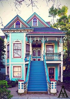 a blue and white house with stairs leading up to it