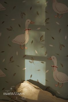 two white ducks floating in the air above a bed with leaves on it's wall