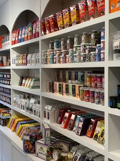 a store filled with lots of different types of food and drink bottles on shelves next to each other