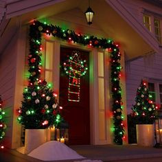 a house decorated with christmas lights and wreaths