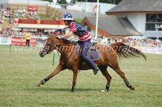 a woman riding on the back of a brown horse