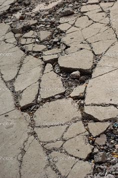 an umbrella is sitting on the cracked pavement