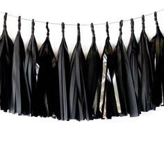 black tissue tassels hanging on a string