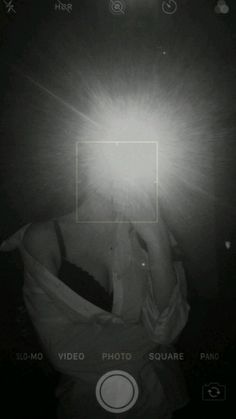 a person holding their head in front of the camera with light coming from behind them