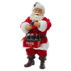 a santa clause figurine holding a coca - cola bag