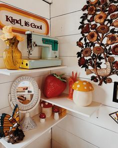 there are many items on the shelves in this room that is decorated with flowers and butterflies