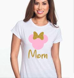 a woman wearing a minnie mouse t - shirt with the word mom printed on it