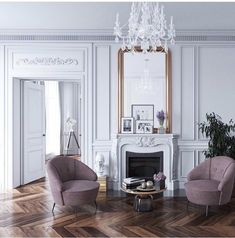 a living room filled with furniture and a fire place in the middle of a wooden floor