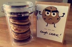 a stack of cookies in a jar next to a card with an image of a cookie on it