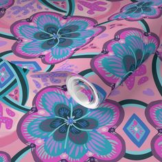 a pink and blue flower wallpaper with an abstract design on the back side of it