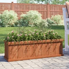 a large wooden planter sitting on top of a brick patio