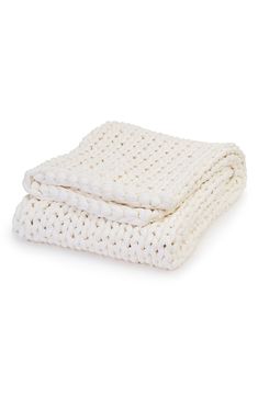 the white blanket is folded on top of each other, and it's made out of