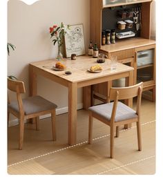 a small wooden table with two chairs next to it