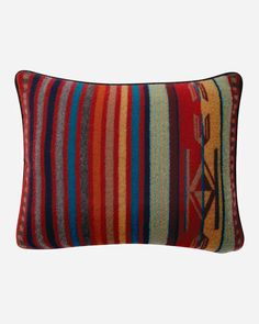 a multicolored striped pillow on a white background