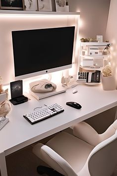 a white desk with a computer monitor and keyboard