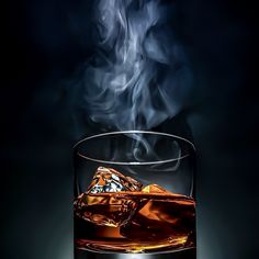 a glass filled with liquid and ice sitting on top of a table