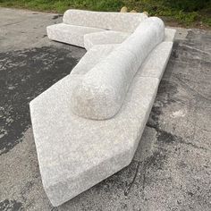 two couches sitting on top of each other in the parking lot