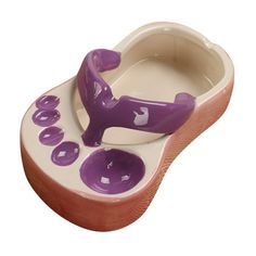 a purple and white ceramic shoe shaped dish