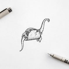 a drawing of an animal with a hat on it's head is shown next to a pen