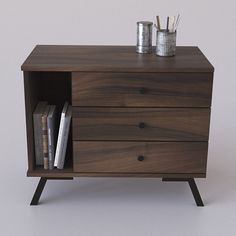 a wooden cabinet with two drawers and some books