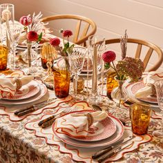 the table is set with dishes and place settings