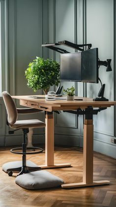 a computer desk with two monitors and a plant on it in front of a window