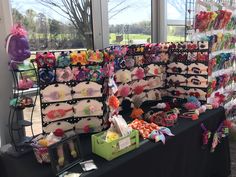 there are many items on the table for sale at this event, including headbands and hair clips