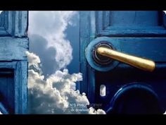 an open door with a golden handle in front of a cloudy blue sky and white clouds