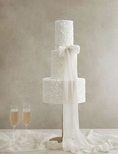 a wedding cake and two glasses of champagne